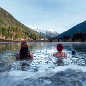 Cold plungers sit in the freshwater pond “The Oasis” looking out to the Bedwell Valley, which is home to the Clayoquot Wilderness Lodge.