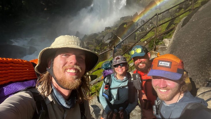 Hikers in front of waterfall