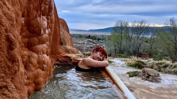 Author Emily Pennington relaxes at Mystic Hot Springs in Utah