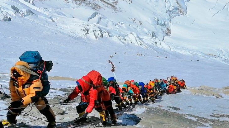 In this May 22, 2019, file photo, a long queue of mountain climbers line a path on Mount Everest just below camp four, in Nepal.