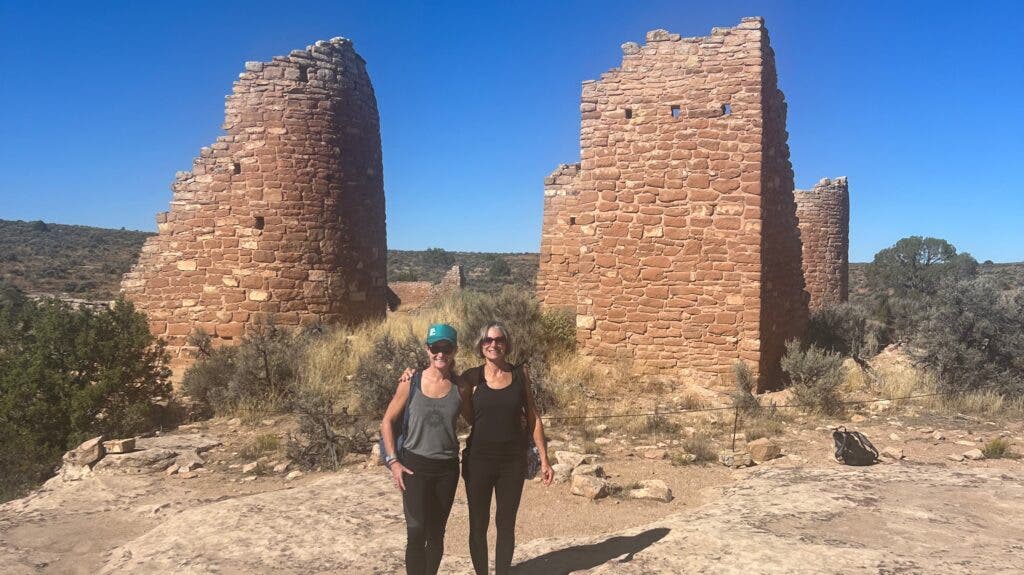 The author and her mother posing in front of Indigenous ruins at Canyons of the Ancients National Monument, Colorado
