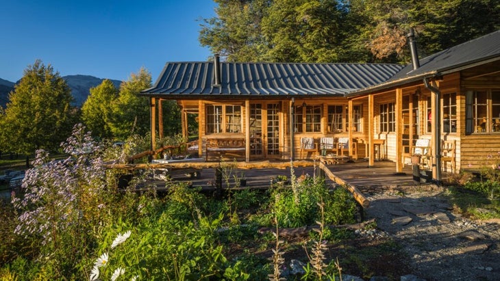 The charming wooden exterior and forest surrounds of the Mallin Colorado Ecolodge in the Aysén region of Chile