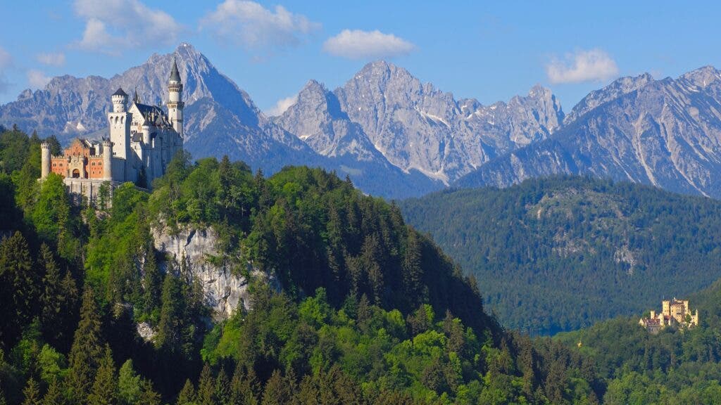Germany’s Neuschwanstein Castle backed by the foothills of the Alps and, right, another castle, Hohenschwangau