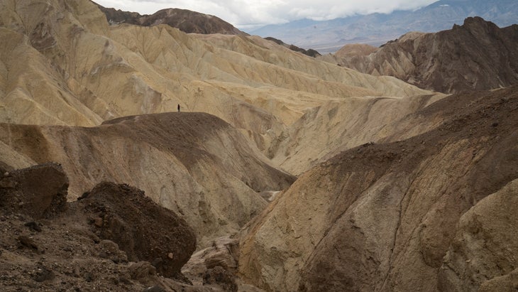 Person hikes down a canyon in Death Valley National Park