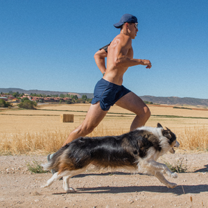 man running with dog outside