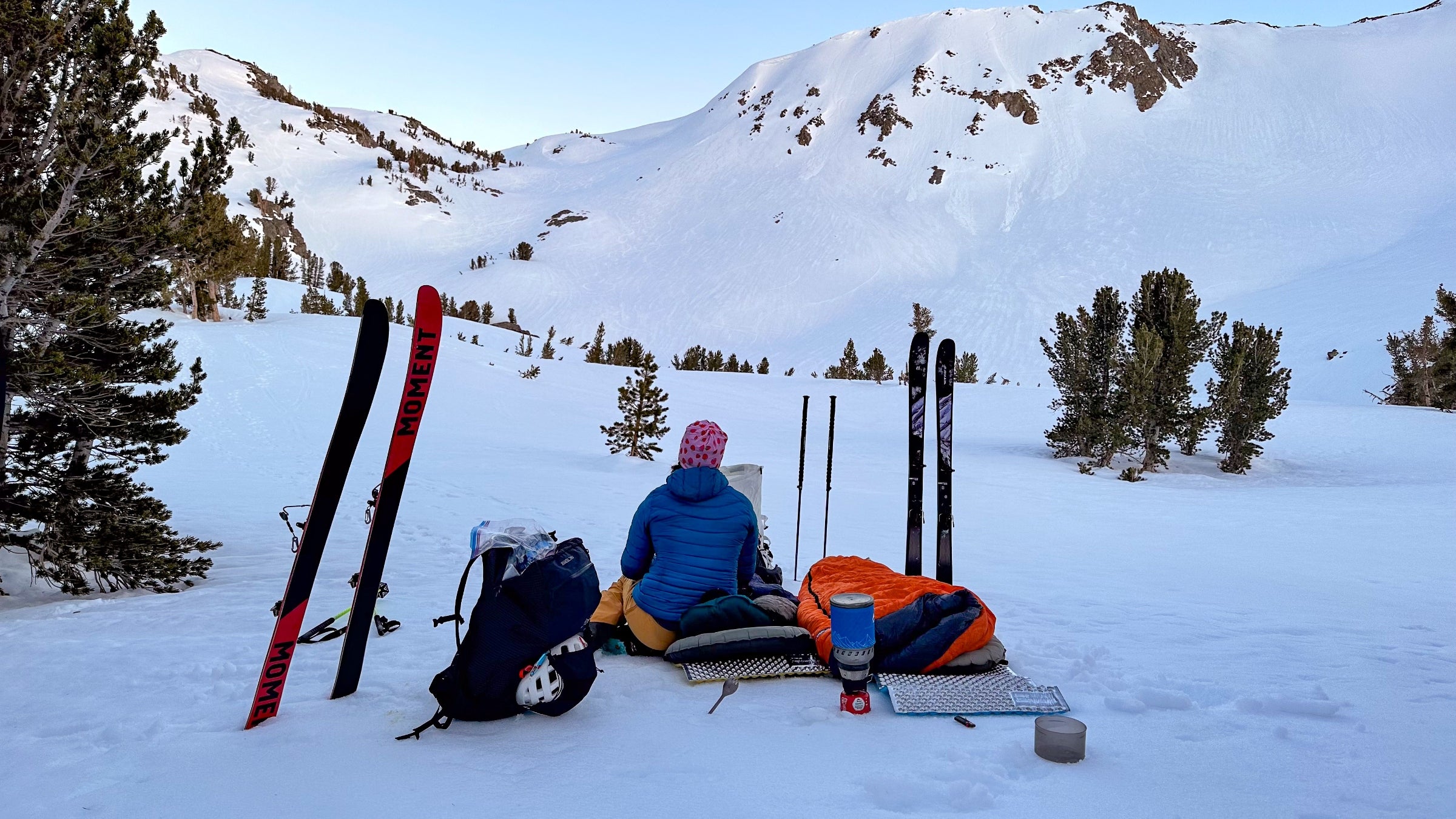 A skier looks up at a ridgeline
