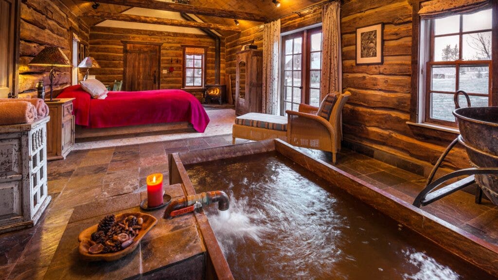 An in-room hot spring is the attraction at Dunton’s Well House Cabin.