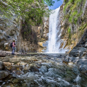 A young hiker looks at Canyon Falls in San Gabriel Mountains National Monument