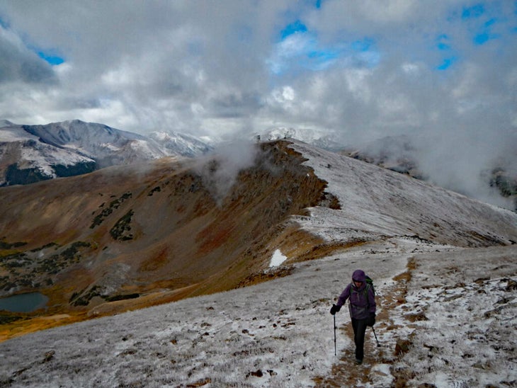 Snow dusted mountain on an autumn day with hiker