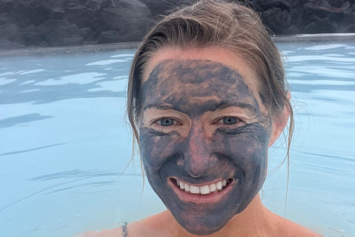 The author immersed in the hot waters of Iceland’s Blue Lagoon, with mud on her face. It beats being on the phone trying to reschedule a flight cancellation.
