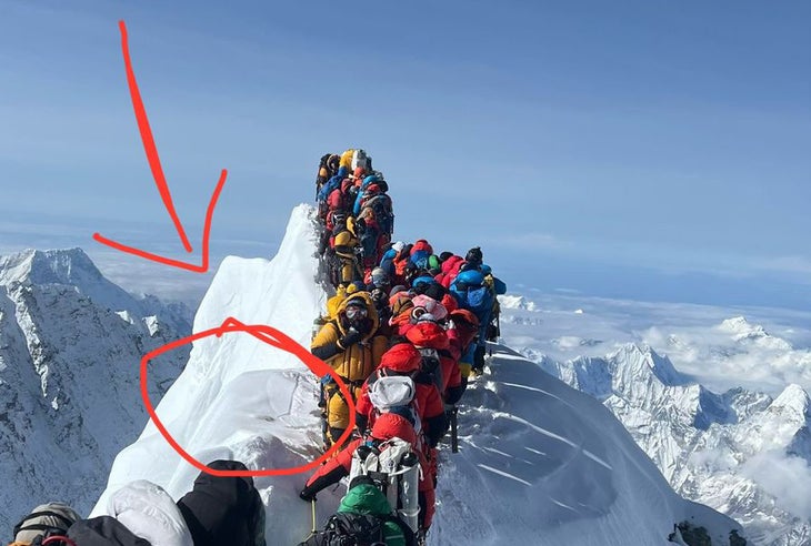 Climbers stand on a summit ridge on Mount Everest.