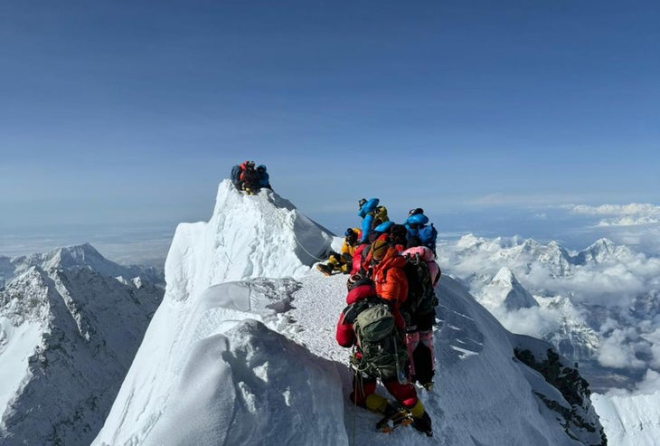 Climbers stand on either size of a fall zone on Mount Everest.