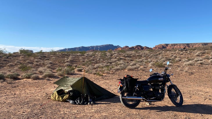 One-man shelter pitched next to motorcycle in Nevada desert