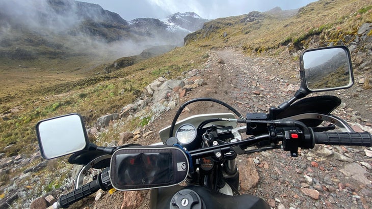 View of mountains in Ecuador over motorcycle handlebar