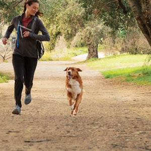 Woman and dog running together.