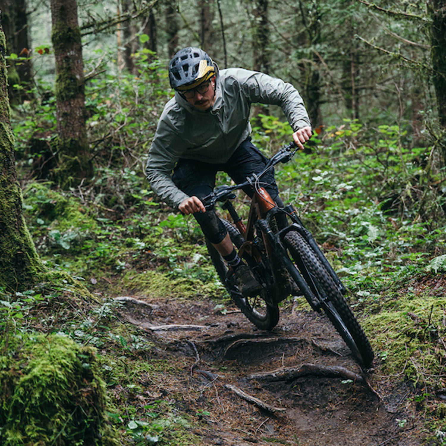 Male mountain biker on Trek Slash+ electric mountain bike on wooded singletrack trail
