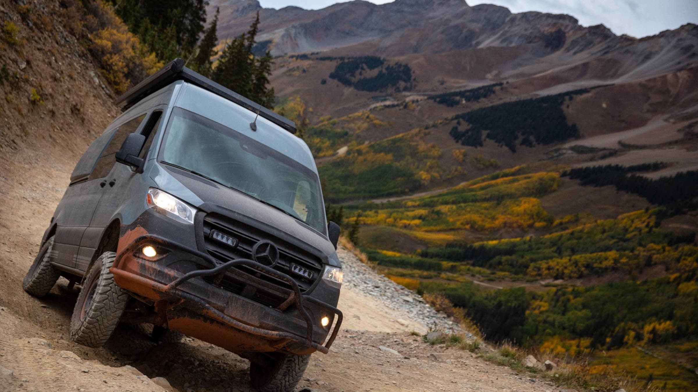 Sprinter van navigating rocky mountain pass in the Rockies.