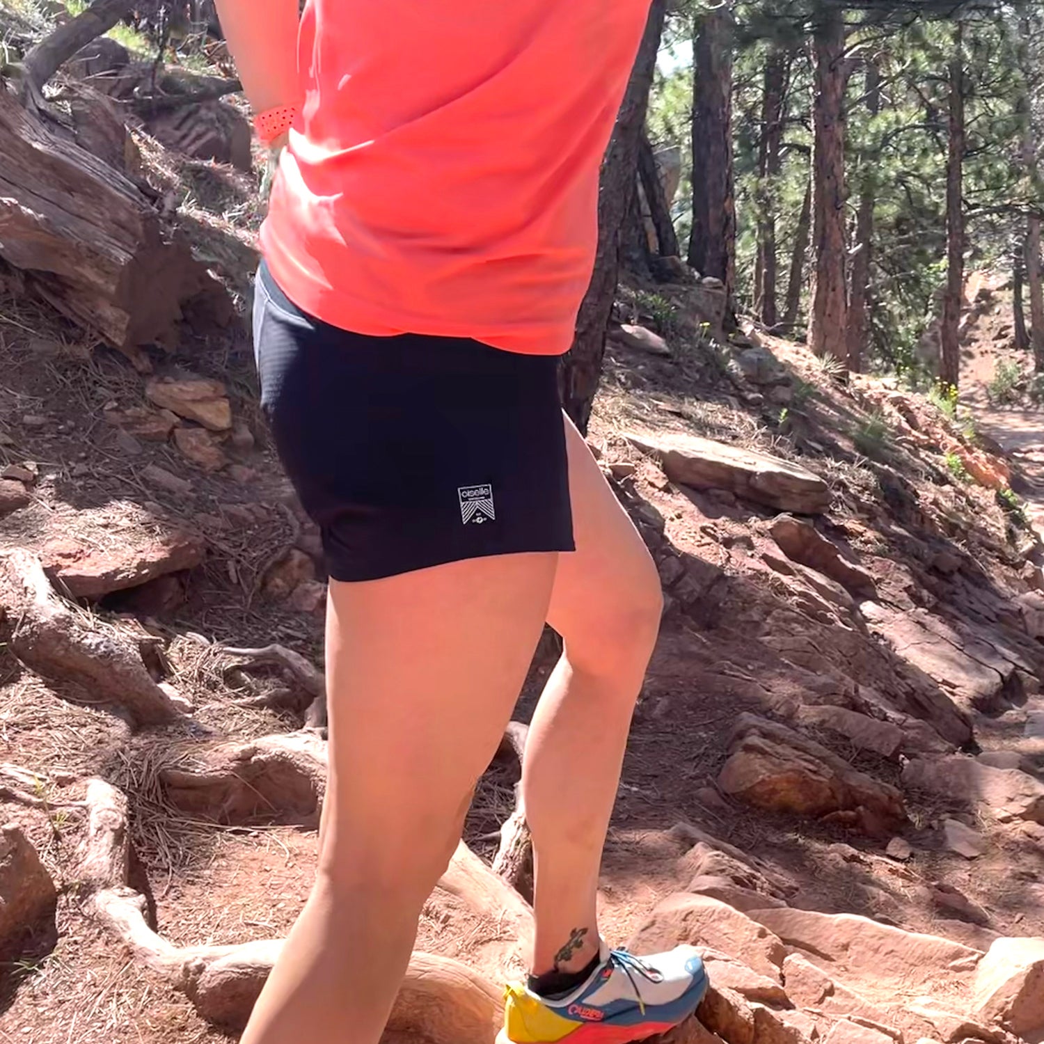 Side sot of women's running shorts on a rooty trail