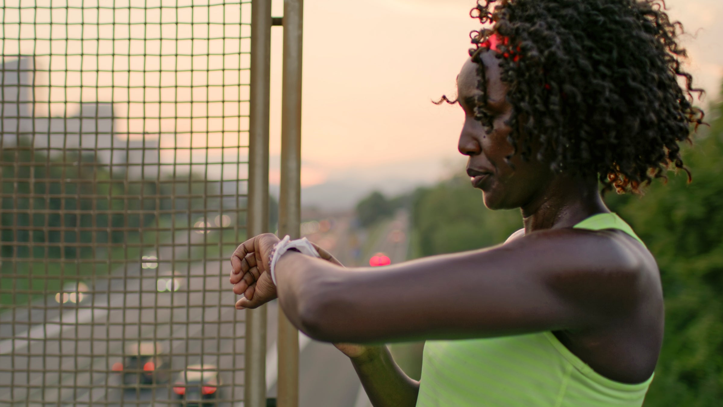 Female athlete checks time during workout