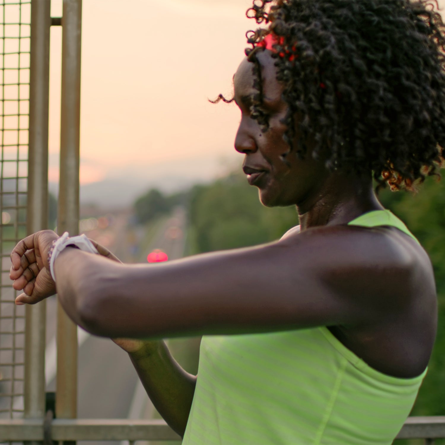 Female runner checks time during workout