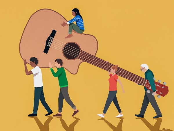Group of miniature people carrying an oversized guitar