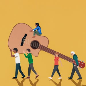 Group of miniature people carrying an oversized guitar
