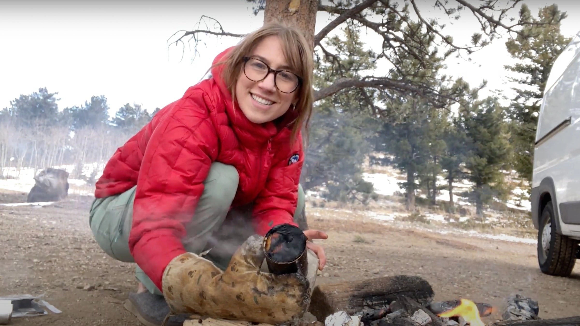 camper holding cooking tools