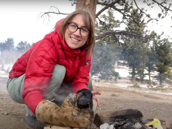 camper holding cooking tools