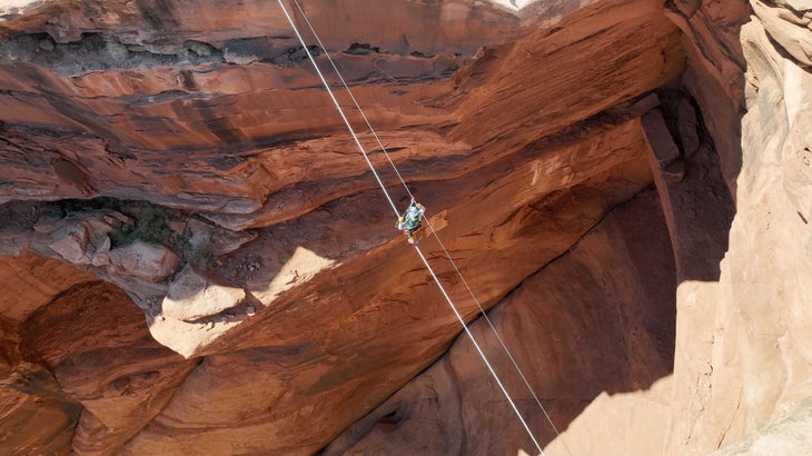 student highlining with hand cables as backup