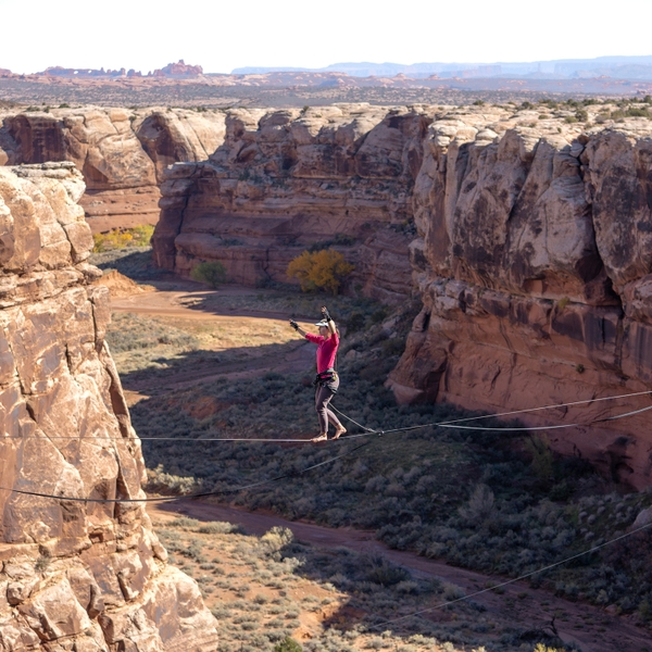 woman highlining across canyon in Moab area