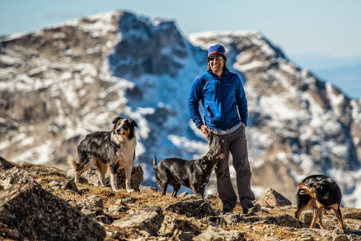 man hiking with dogs