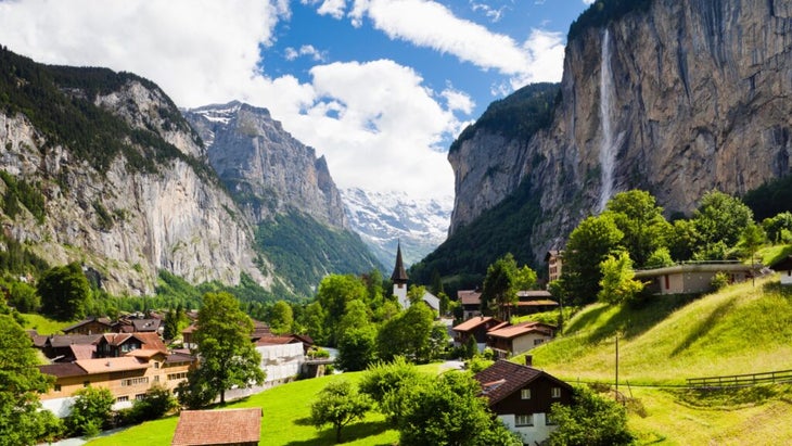 A waterfall drops down a sheer Alpine face into Switzerland’s verdant Lauterbrunnen Valley.