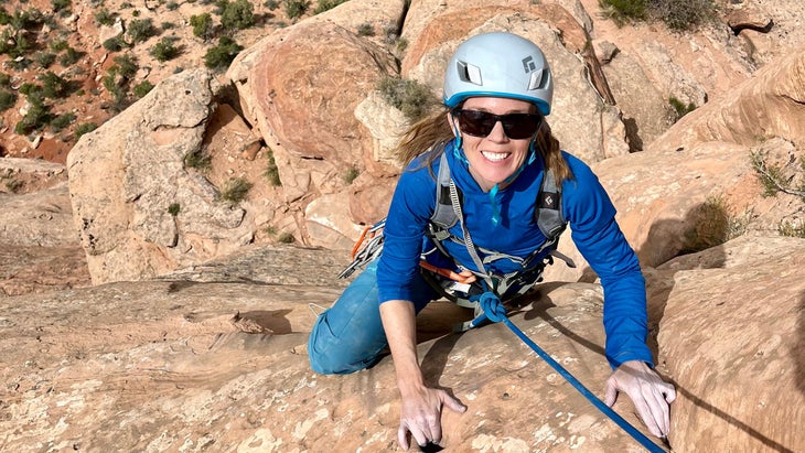 woman climbing desert tower, Colorado National Monument