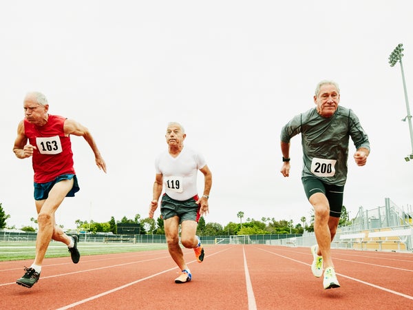 Three older men running a race on a track