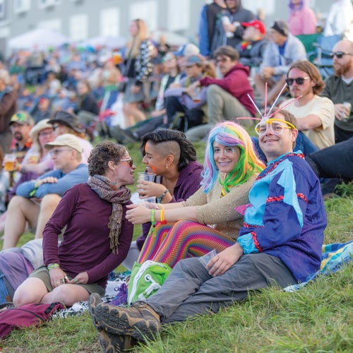 Concert-goers enjoying an evening set at one of two main stages