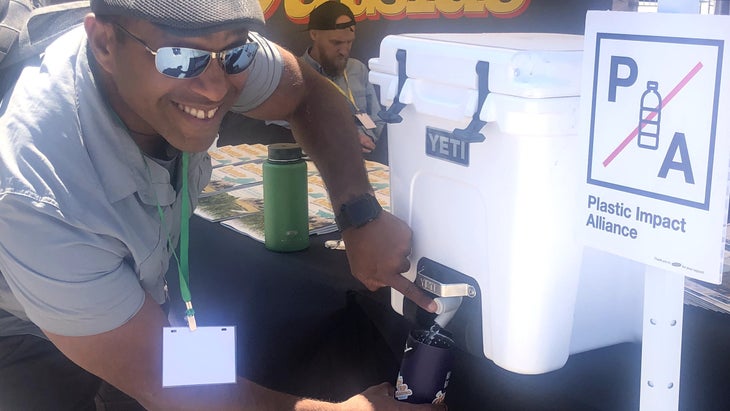 Man refilling a water bottle at a Leave No Trace festival