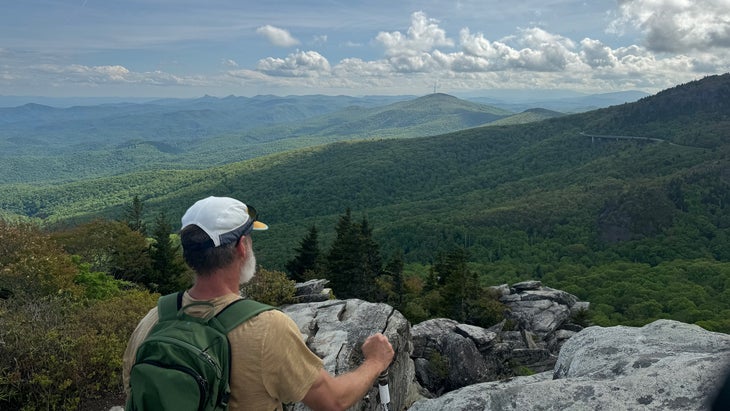 Hiker looks down on Linn Cove Viaduct