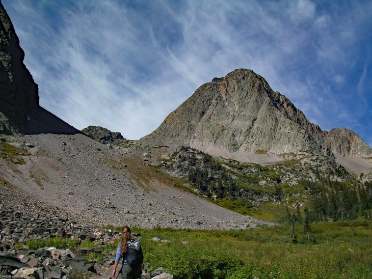 Woman approaching large mountain