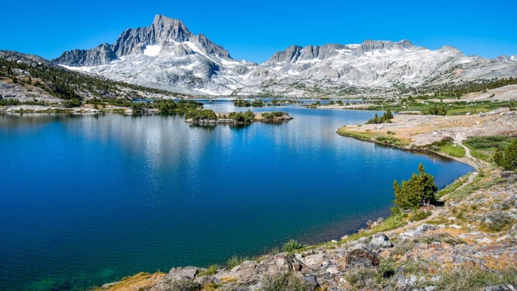 The cobalt blue of Thousand Island Lake reflects the sky on a sunny Sierra day, with Banner Peak in the distance.