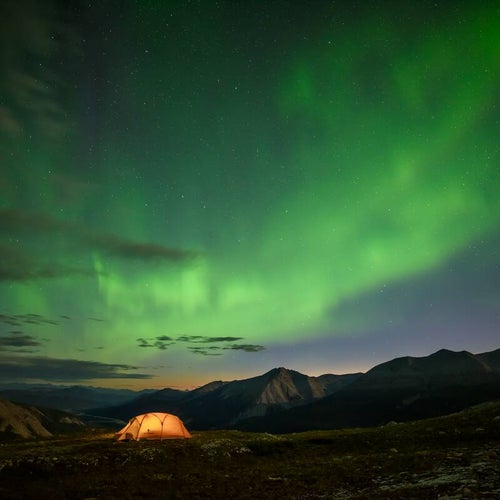A tent under the Northern Lights on Summit Peak Trail