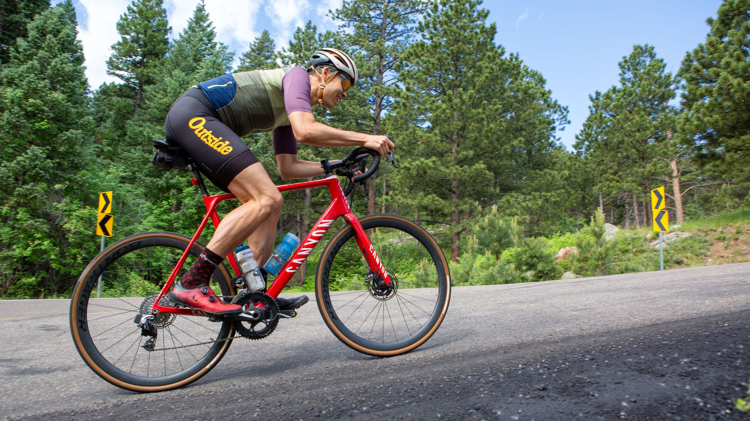 A cyclist rides a road bike on a steep incline.