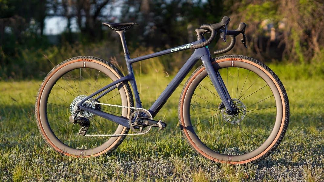 Black Cervelo Aspero gravel bike staged on grassy field in sunlight