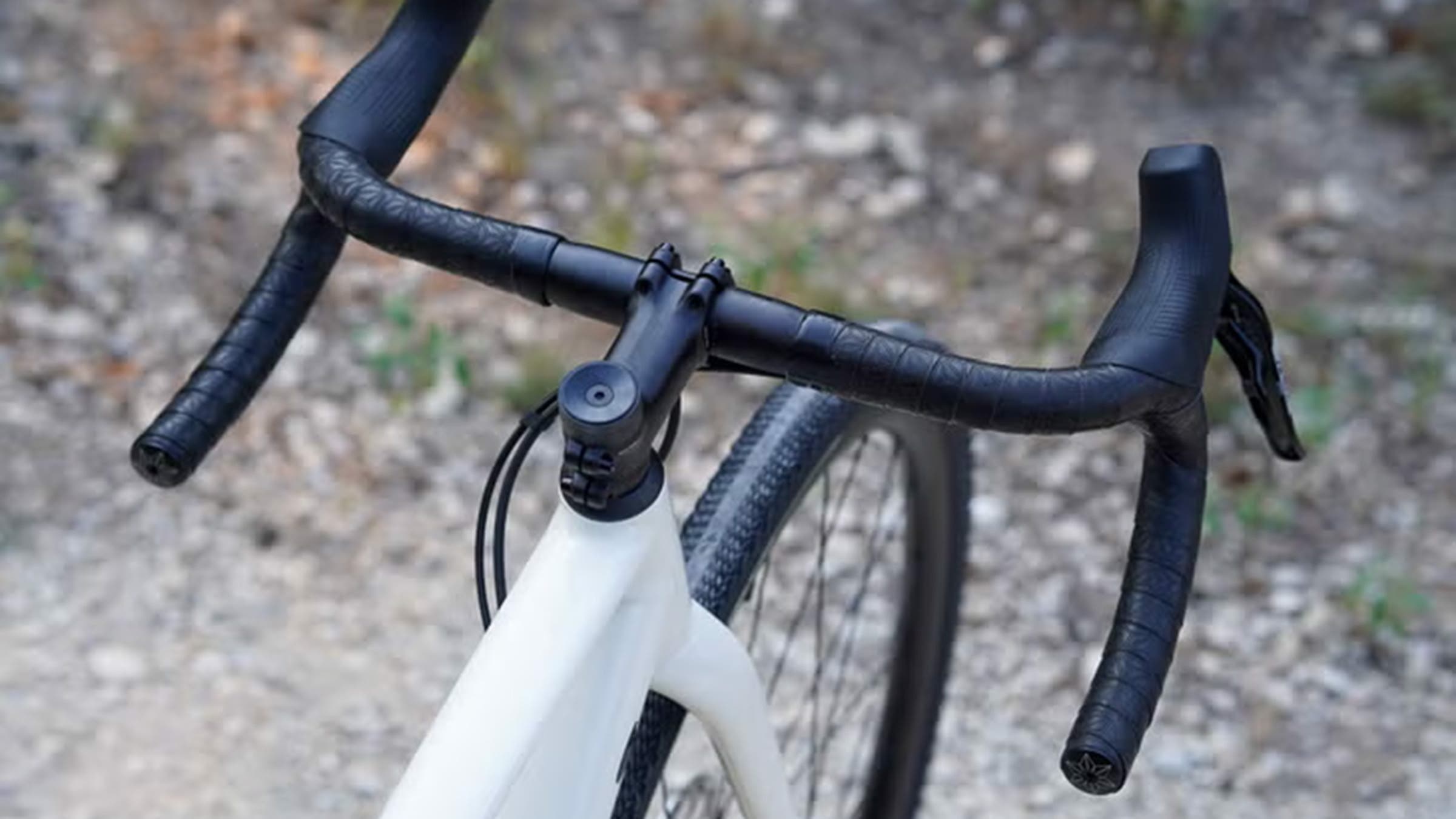 Closeup of black gravel bike handlebars on bike