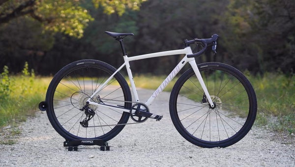 White Specialized Crux DSW gravel bike staged in middle of gravel path