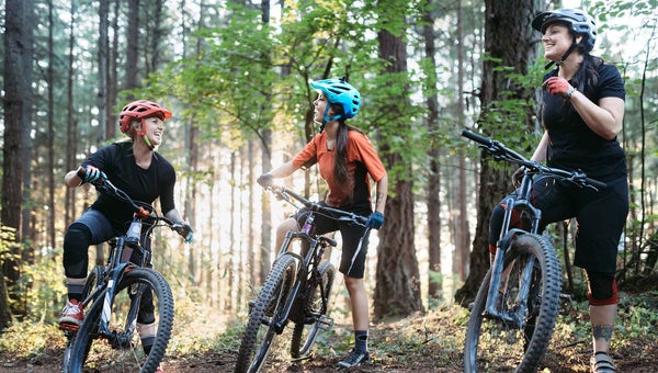 A group of women riding mountain bike trails in the Pacific Northwest.