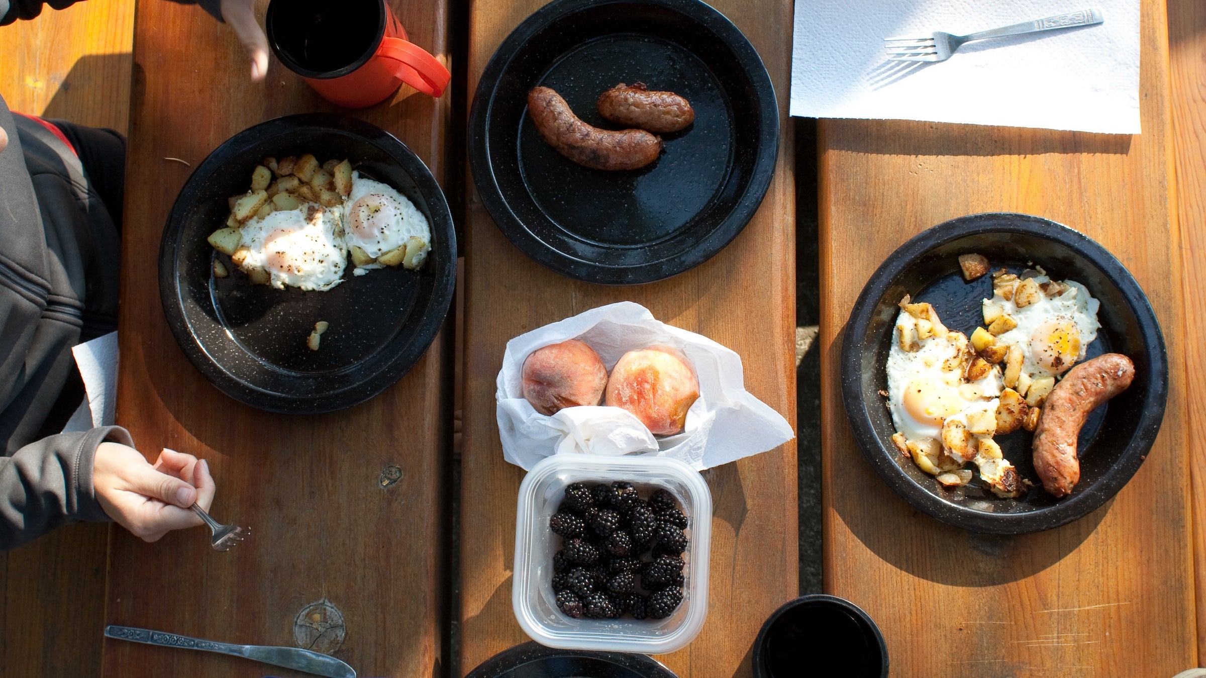 top-down view of fruit sausage and eggs on a picnic table