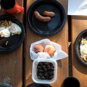 top-down view of fruit sausage and eggs on a picnic table