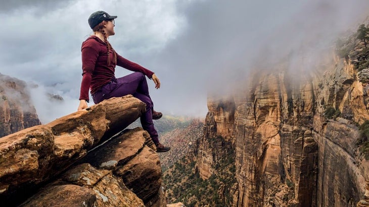 The author sitting on an edge of rock at Zion鈥檚 Canyon Overlook.