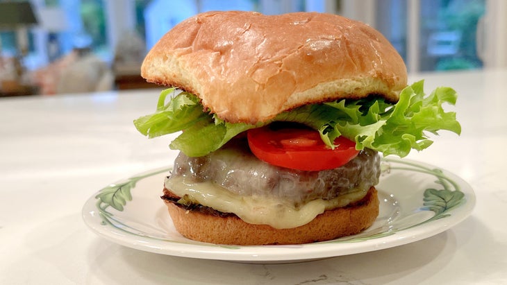 Beef burger with melted cheese, lettuce and tomato