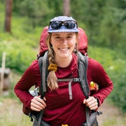 Writer Kylie Mohr wearing a backpack in the outdoors